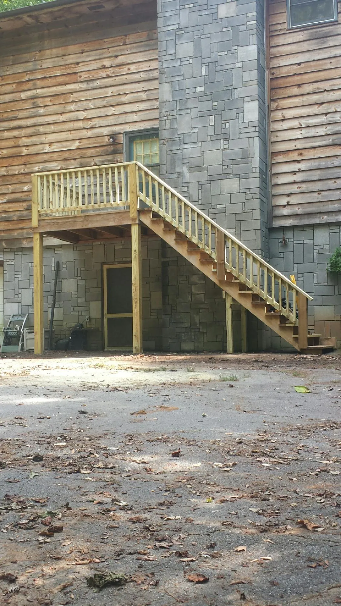 New pressure treated deck and stair landing on a log home in Lyndora